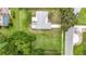 Aerial perspective of a home with a backyard, showcasing ample green space and proximity to lush trees at 8329 Gulf Way, Hudson, FL 34667