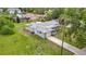 Aerial view of gray single-story home with driveway and mature trees at 8329 Gulf Way, Hudson, FL 34667