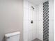 Modern bathroom featuring mosaic tile accents, a shower, and neutral walls at 8329 Gulf Way, Hudson, FL 34667