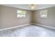 Spacious bedroom with dual windows and marble-look floors at 8329 Gulf Way, Hudson, FL 34667