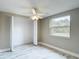 Bedroom features neutral walls, marble floors, a closet, and a bright window at 8329 Gulf Way, Hudson, FL 34667