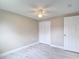 Neutral bedroom featuring a ceiling fan, a closet, and sleek marble flooring at 8329 Gulf Way, Hudson, FL 34667