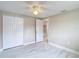 Neutral bedroom highlighting a ceiling fan, closet, and marble flooring at 8329 Gulf Way, Hudson, FL 34667