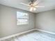 Bedroom features neutral walls, marble floors, and a bright window at 8329 Gulf Way, Hudson, FL 34667