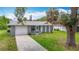 A charming single-story home with an attached garage, a well-maintained lawn, and inviting curb appeal at 8329 Gulf Way, Hudson, FL 34667