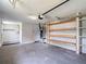 Spacious garage with open shelving, washer, and dryer hookups, and a utility sink at 8329 Gulf Way, Hudson, FL 34667