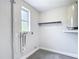 Cozy laundry room with a window and storage at 8329 Gulf Way, Hudson, FL 34667