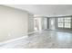 Bright living room featuring marble-look floors, neutral paint, front door with window and a large window at 8329 Gulf Way, Hudson, FL 34667
