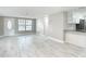 Open-concept living space with new flooring, neutral colors and kitchen area at 8329 Gulf Way, Hudson, FL 34667
