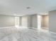 Spacious living room featuring marble-look floors, neutral paint, and multiple doorways at 8329 Gulf Way, Hudson, FL 34667