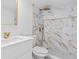 Updated bathroom featuring marble-look shower and gold fixtures at 9053 Hickory Cir, Tampa, FL 33615
