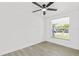 Bright bedroom with light wood-look flooring and ceiling fan at 9053 Hickory Cir, Tampa, FL 33615