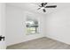 Bright bedroom with light wood-look flooring and ceiling fan at 9053 Hickory Cir, Tampa, FL 33615