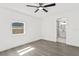 Bedroom with a ceiling fan, wood-look flooring, and natural light from the window at 9053 Hickory Cir, Tampa, FL 33615