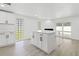 Kitchen area featuring a kitchen island, sliding doors with outdoor access, and tile flooring at 9053 Hickory Cir, Tampa, FL 33615