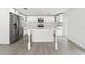 Bright kitchen with white cabinets, stainless steel appliances, and an island with seating at 9053 Hickory Cir, Tampa, FL 33615