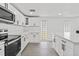 Bright kitchen featuring a tile backsplash, stainless steel appliances, and ample counter space at 9053 Hickory Cir, Tampa, FL 33615