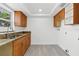 Functional laundry area featuring ample cabinetry, granite countertops, and bright, natural light at 9053 Hickory Cir, Tampa, FL 33615