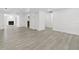 Spacious living area showcasing sleek flooring, recessed lighting, and a seamless transition to adjacent rooms at 9053 Hickory Cir, Tampa, FL 33615