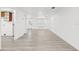 Expansive open living area featuring modern flooring, neutral decor, and a seamless flow to other parts of the home at 9053 Hickory Cir, Tampa, FL 33615