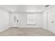 Bright, open-concept living room featuring modern flooring, fresh white walls, and a welcoming front door at 9053 Hickory Cir, Tampa, FL 33615