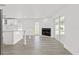 Open-concept living area with a fireplace, sliding glass doors, and island seating at 9053 Hickory Cir, Tampa, FL 33615