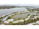 Aerial view of a condo community surrounding a scenic pond, with a pool and clubhouse at 101 Pompano Se Dr # C, St Petersburg, FL 33705