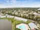 Aerial view showcases community pool, clubhouse and scenic pond with waterfront condos at 101 Pompano Se Dr # C, St Petersburg, FL 33705