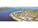 Stunning aerial shot features waterfront condos, a scenic pond, and a bay in the distance at 101 Pompano Se Dr # C, St Petersburg, FL 33705