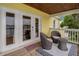 Water view balcony furnished with wicker chairs and table, accessible through glass doors at 101 Pompano Se Dr # C, St Petersburg, FL 33705