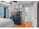 Bedroom with blue dresser, TV, and access to the kitchen at 101 Pompano Se Dr # C, St Petersburg, FL 33705