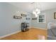 Stylish dining area with a modern bar cart, unique light fixture, and bright, airy feel with wood flooring at 101 Pompano Se Dr # C, St Petersburg, FL 33705