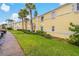 Exterior of townhomes with lush lawn, palm trees, and convenient parking at 101 Pompano Se Dr # C, St Petersburg, FL 33705