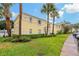 Building 68 exterior with well-maintained lawn, landscaping, and ample parking at 101 Pompano Se Dr # C, St Petersburg, FL 33705