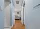 Hallway with wood floors leading to the living room with gray couch at 101 Pompano Se Dr # C, St Petersburg, FL 33705