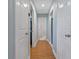 Hallway with wood floors and doors leading to other rooms in the home at 101 Pompano Se Dr # C, St Petersburg, FL 33705