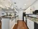 A kitchen area with white cabinets, a black refrigerator, stainless steel dishwasher and sink, and a breakfast bar at 101 Pompano Se Dr # C, St Petersburg, FL 33705