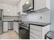 Bright kitchen with white cabinets, stainless steel appliances and subway tile backsplash at 101 Pompano Se Dr # C, St Petersburg, FL 33705