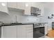 Sleek, modern kitchen with white cabinetry, stainless steel appliances, and a stylish subway tile backsplash at 101 Pompano Se Dr # C, St Petersburg, FL 33705