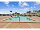 Community pool surrounded by brick pavers, landscaping, and lounge seating at 101 Pompano Se Dr # C, St Petersburg, FL 33705