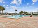 Inviting community pool area features brick pavers, palm trees, and lounge chairs at 101 Pompano Se Dr # C, St Petersburg, FL 33705