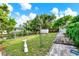 Lush backyard with a pond, storage shed, and wooden deck, perfect for outdoor enjoyment at 10407 Oleander Dr, Port Richey, FL 34668