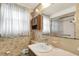 Bathroom featuring wallpaper, vanity and mirror at 10407 Oleander Dr, Port Richey, FL 34668