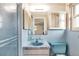 Bathroom featuring blue sink, toilet and tile at 10407 Oleander Dr, Port Richey, FL 34668