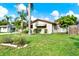 Charming single-story home with a well-maintained lawn and lush landscaping at 10407 Oleander Dr, Port Richey, FL 34668