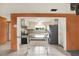 Open kitchen view showing stainless steel refrigerator and breakfast bar at 10407 Oleander Dr, Port Richey, FL 34668
