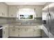 Efficient kitchen featuring ample cabinets, countertops, and stainless steel refrigerator at 10407 Oleander Dr, Port Richey, FL 34668