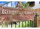 Elegant Kingston Court Villas community sign with a fleur-de-lis design against a wrought iron fence at 120 S Church Ave # 202, Tampa, FL 33609