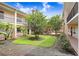 Beautifully landscaped courtyard with mature trees and manicured lawn at 120 S Church Ave # 202, Tampa, FL 33609