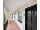 Exterior hallway with unit doors and railings at 120 S Church Ave # 202, Tampa, FL 33609